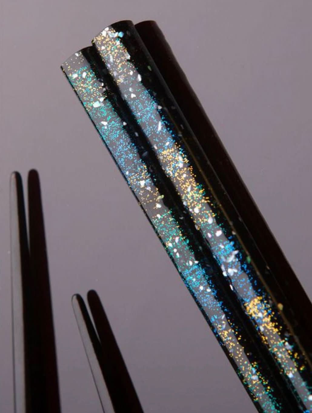 Japanese handmade wooden chopsticks with shimmering glitter accents in blue and gold.